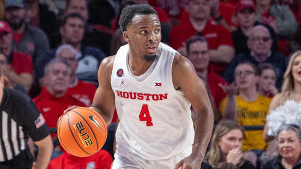 Houston guard L.J. Cryer dribbles against West Virginia